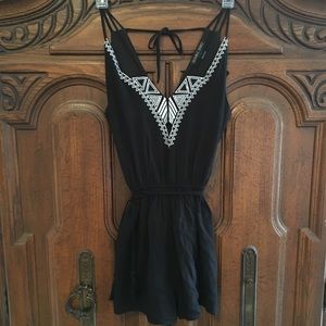 Black romper with white stitched embellishment